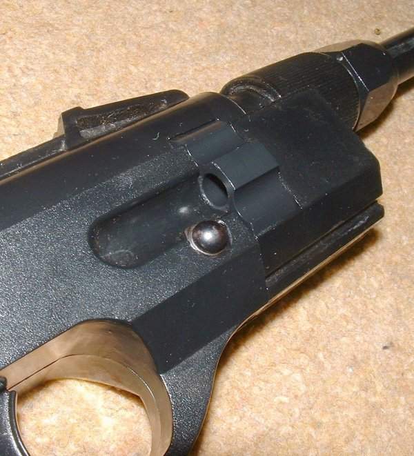 Pellets load through the groove into one of eight chambers in revolver cylinder.