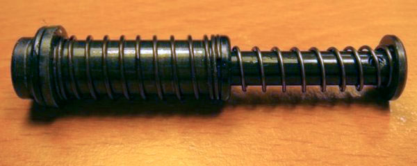 Captive spring on recoil rod