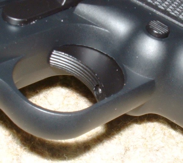Trigger is adjustable for travel via this hole in the trigger face.
