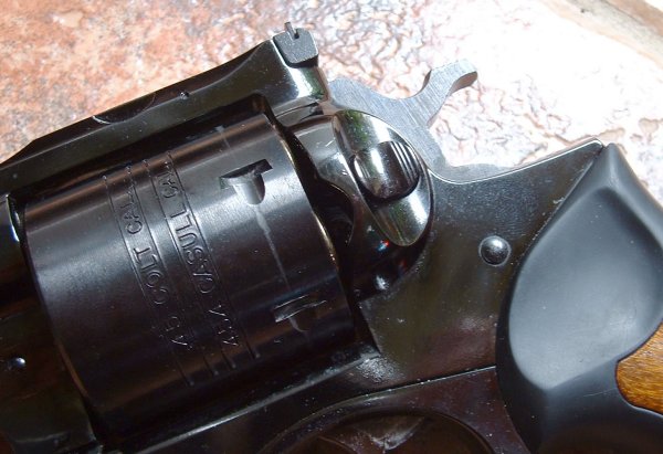 Unfluted cylinder and crane are metal as usual, but lower frame, including trigger guard, is also metal.