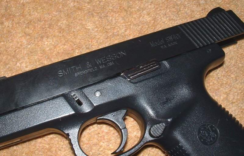 Slide lock larger than Glock's. Note two part trigger.