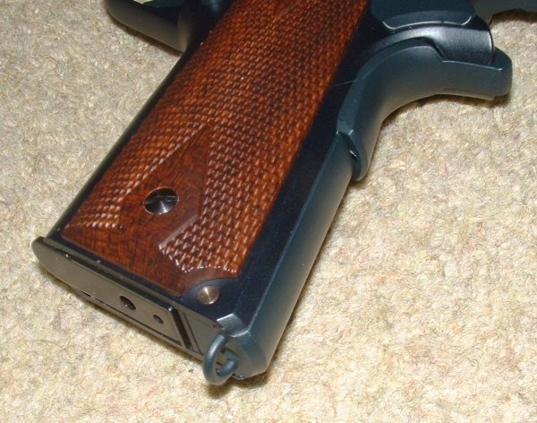'Wood' grips are quite ornate. Note Lanyard ring on base of mainspring cover.