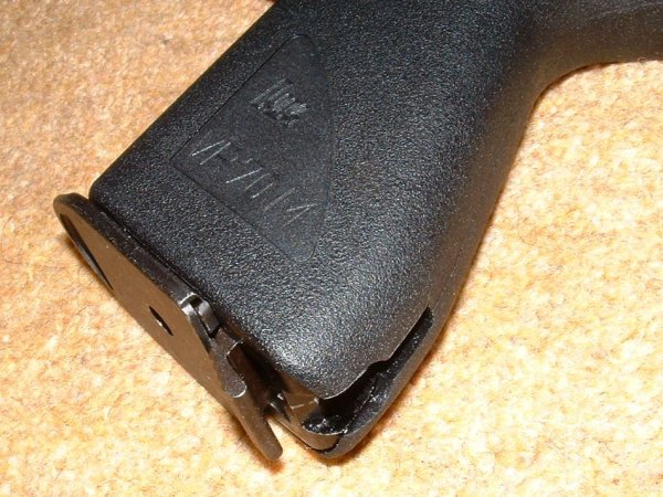 Slot at bottom of grip takes stock connector. Mag release at bottom, like a P38.