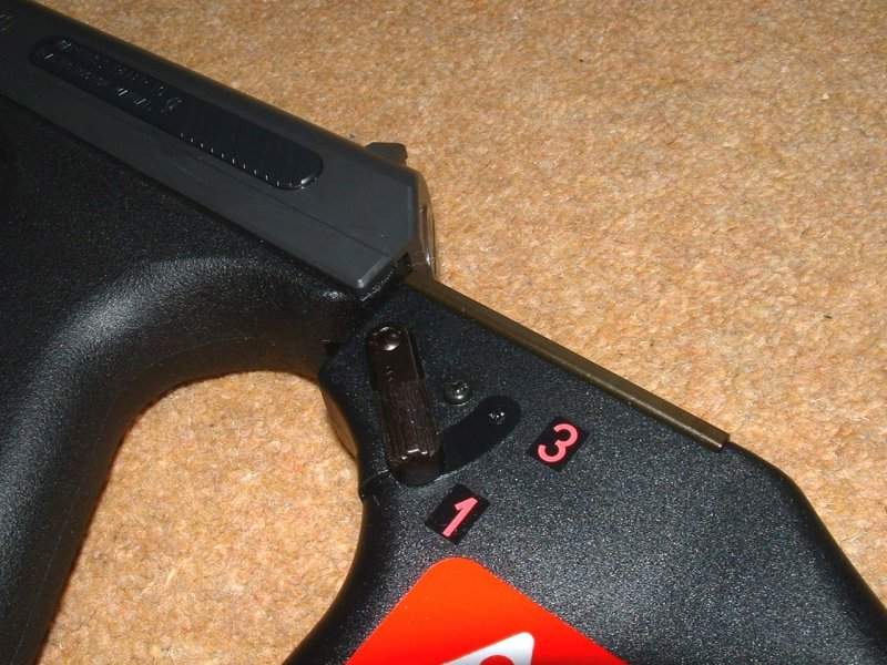 Stock fits into slots in frame at top and bottom of grip.