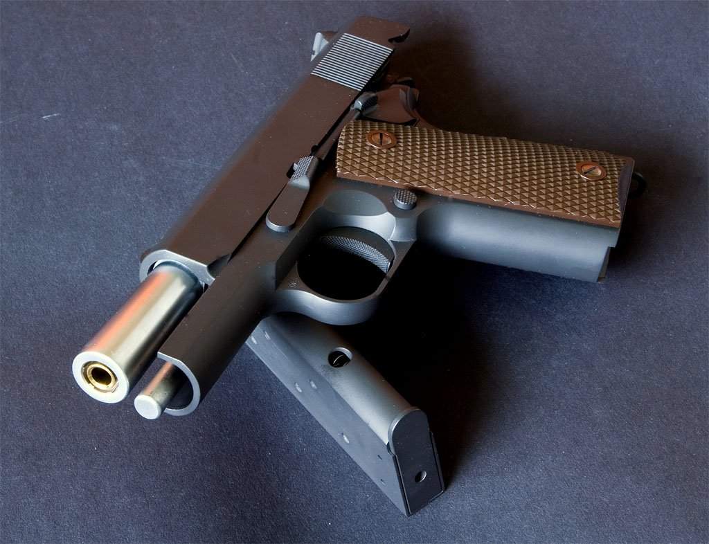 Cut down 1911 features cone barrel and no bushing. Note full length recoil rod, too.